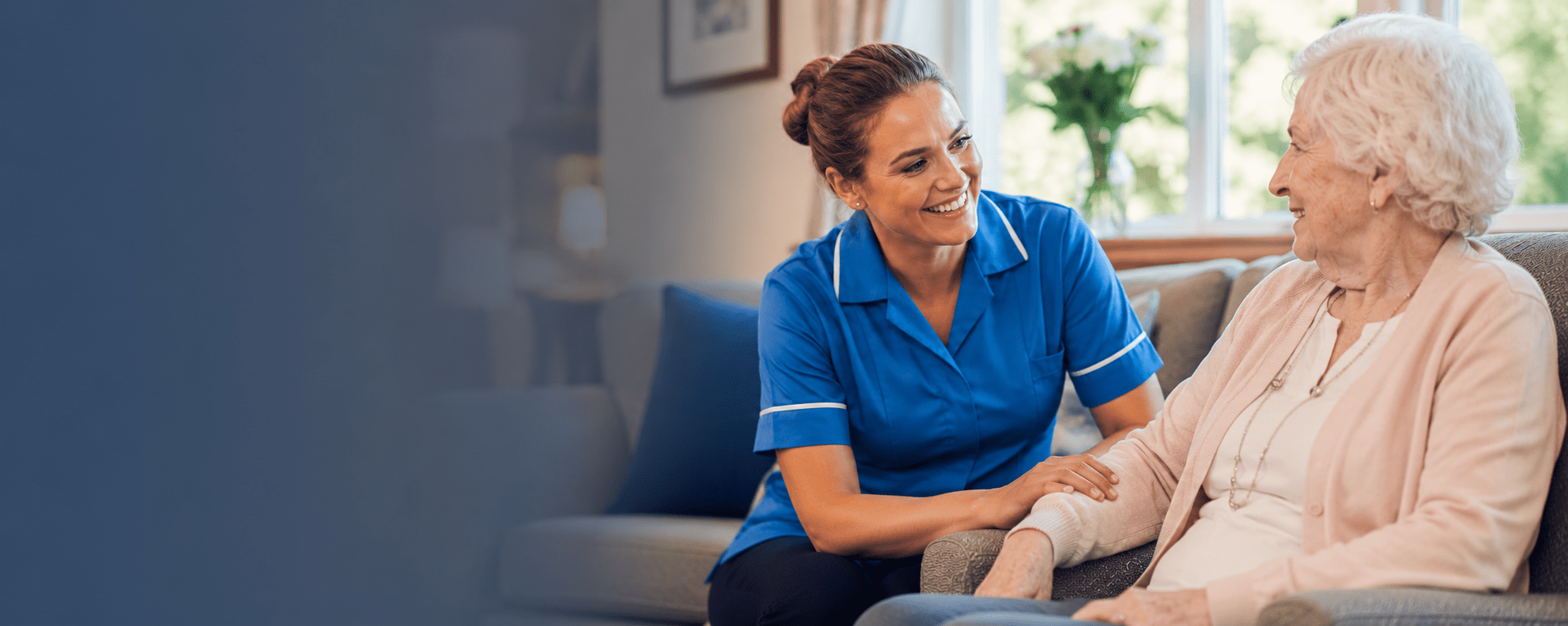 Advantage Angels — Healthcare Staffing Agency UK healthcare staffing agency UK Healthcare assistant in blue uniform providing compassionate care to elderly resident in UK care home